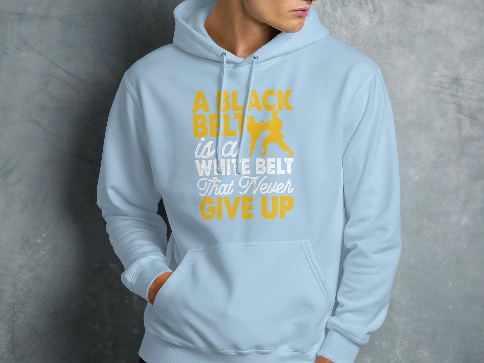 Light blue hoodie with "A black belt is a white belt that never give up" text.