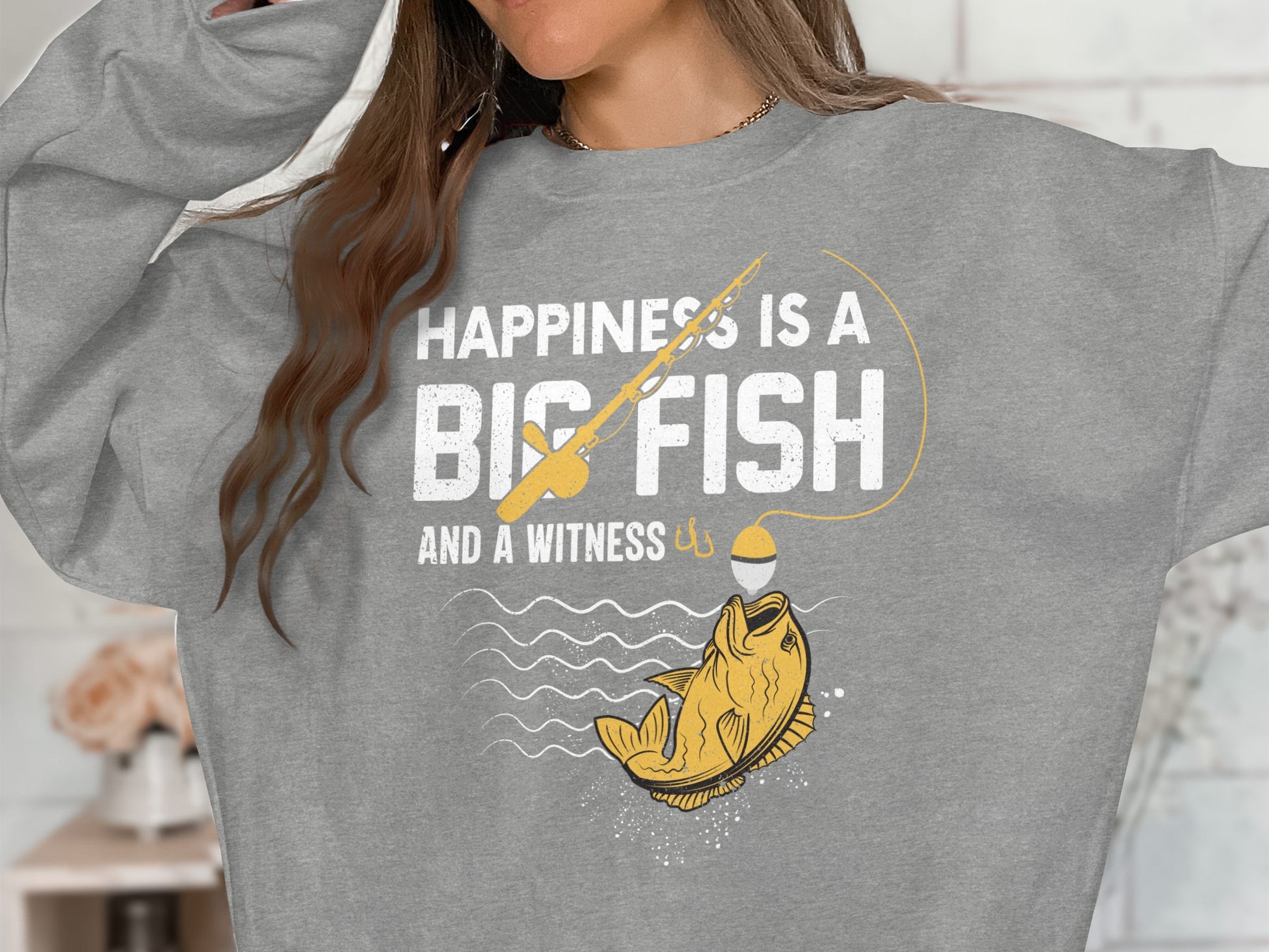 Grey sweatshirt with "Happiness is a big fish and a witness" graphic.