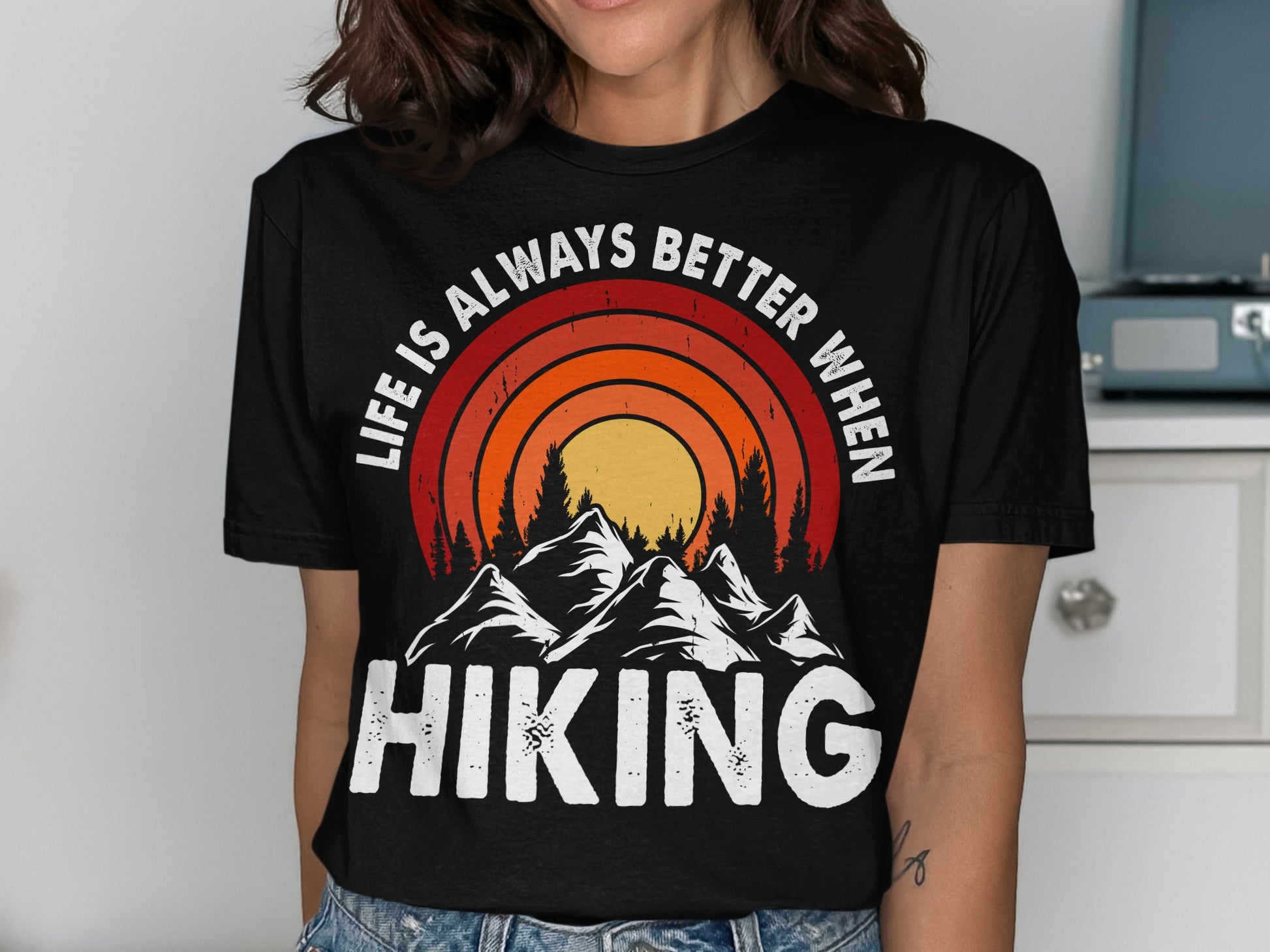 Black t-shirt with "Life is Always Better When Hiking" mountain sunset graphic.
