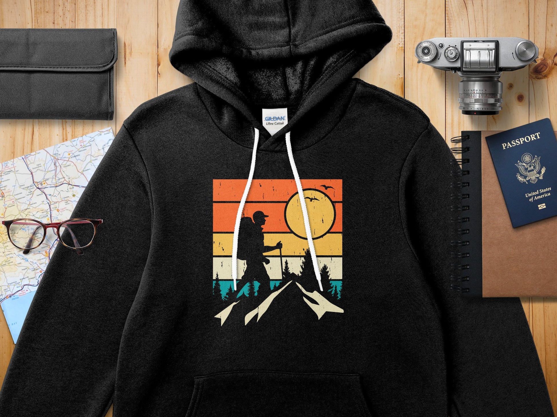 Black hoodie with vintage sunset hiking graphic and passport.
