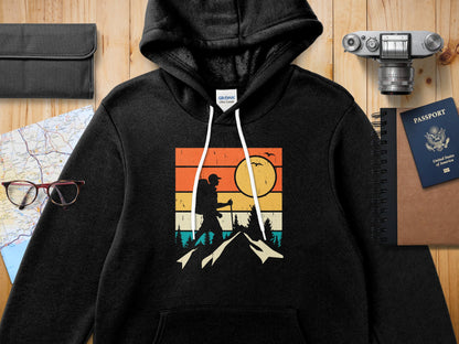 Black hoodie with vintage sunset hiking graphic and passport.