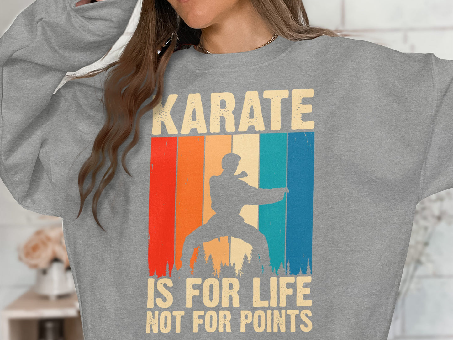 Grey sweatshirt with retro stripe design and karate silhouette and text.