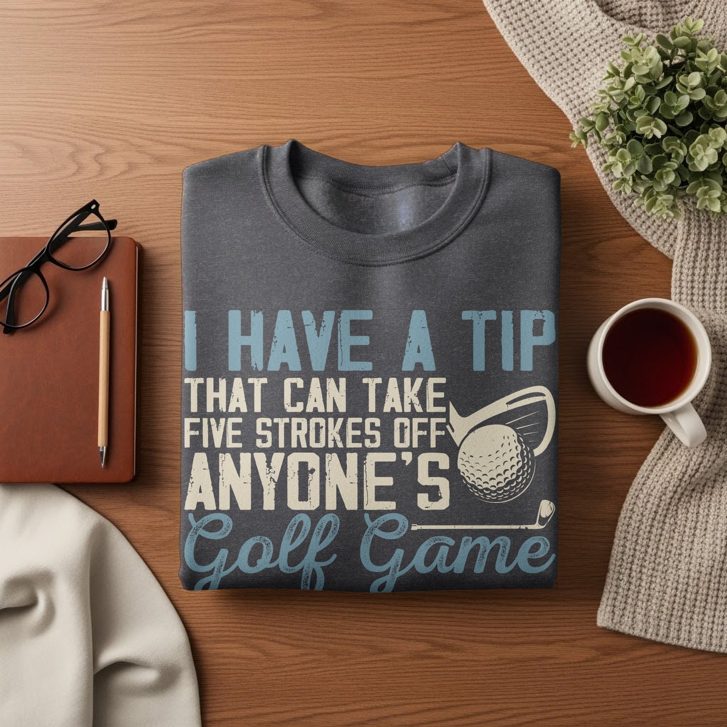 Dark gray t-shirt with text "I HAVE A TIP THAT CAN TAKE FIVE STROKES OFF ANYONE'S Golf Game."