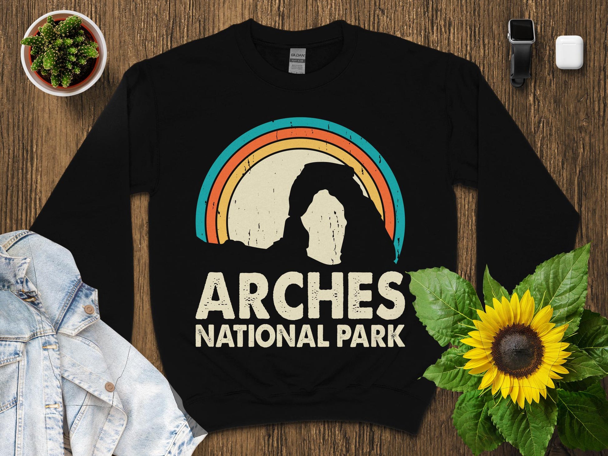 Black sweatshirt with "Arches National Park" and a rainbow arch graphic.