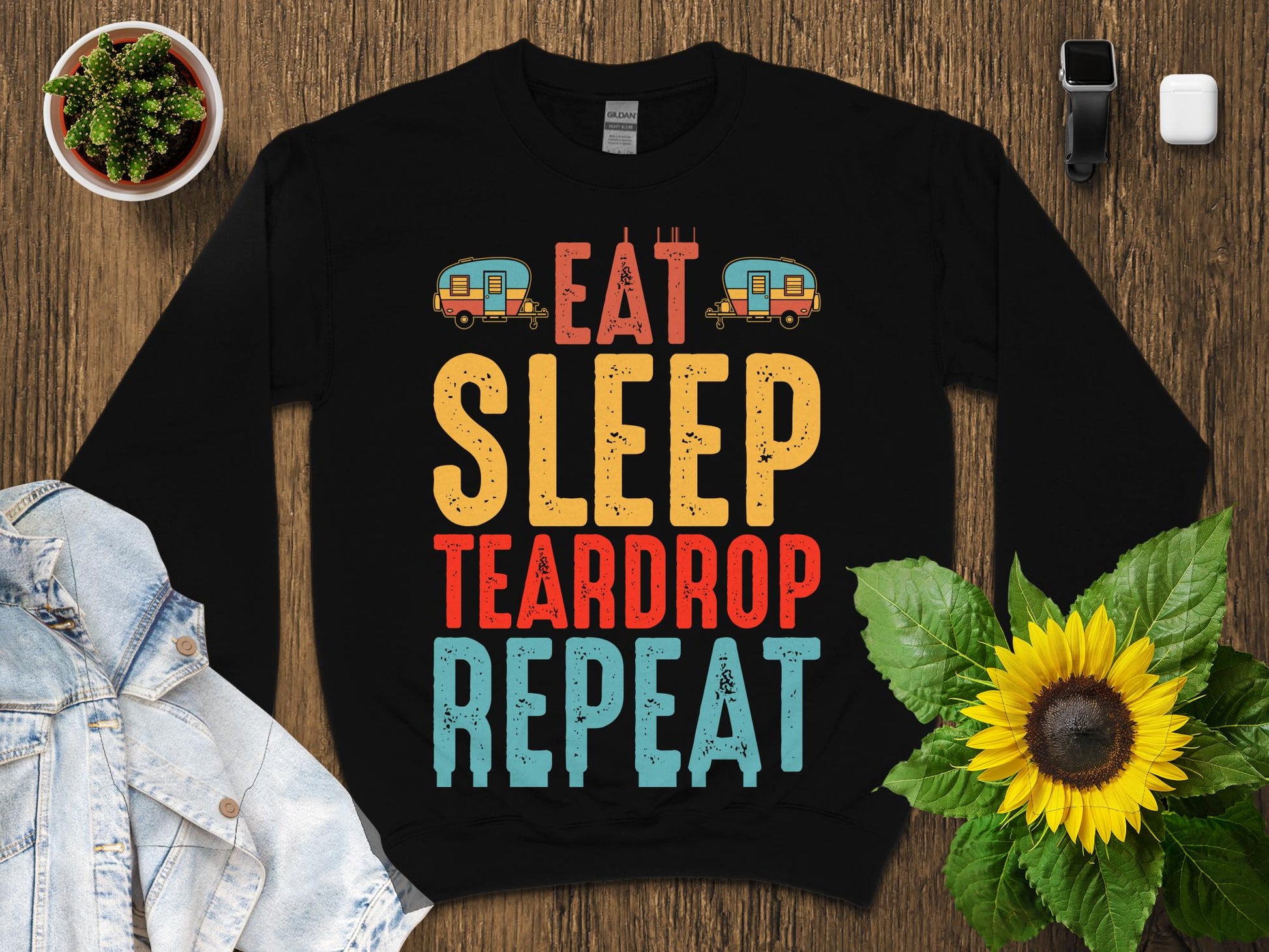 Black sweatshirt with "Eat Sleep Teardrop Repeat" text and camping graphics.