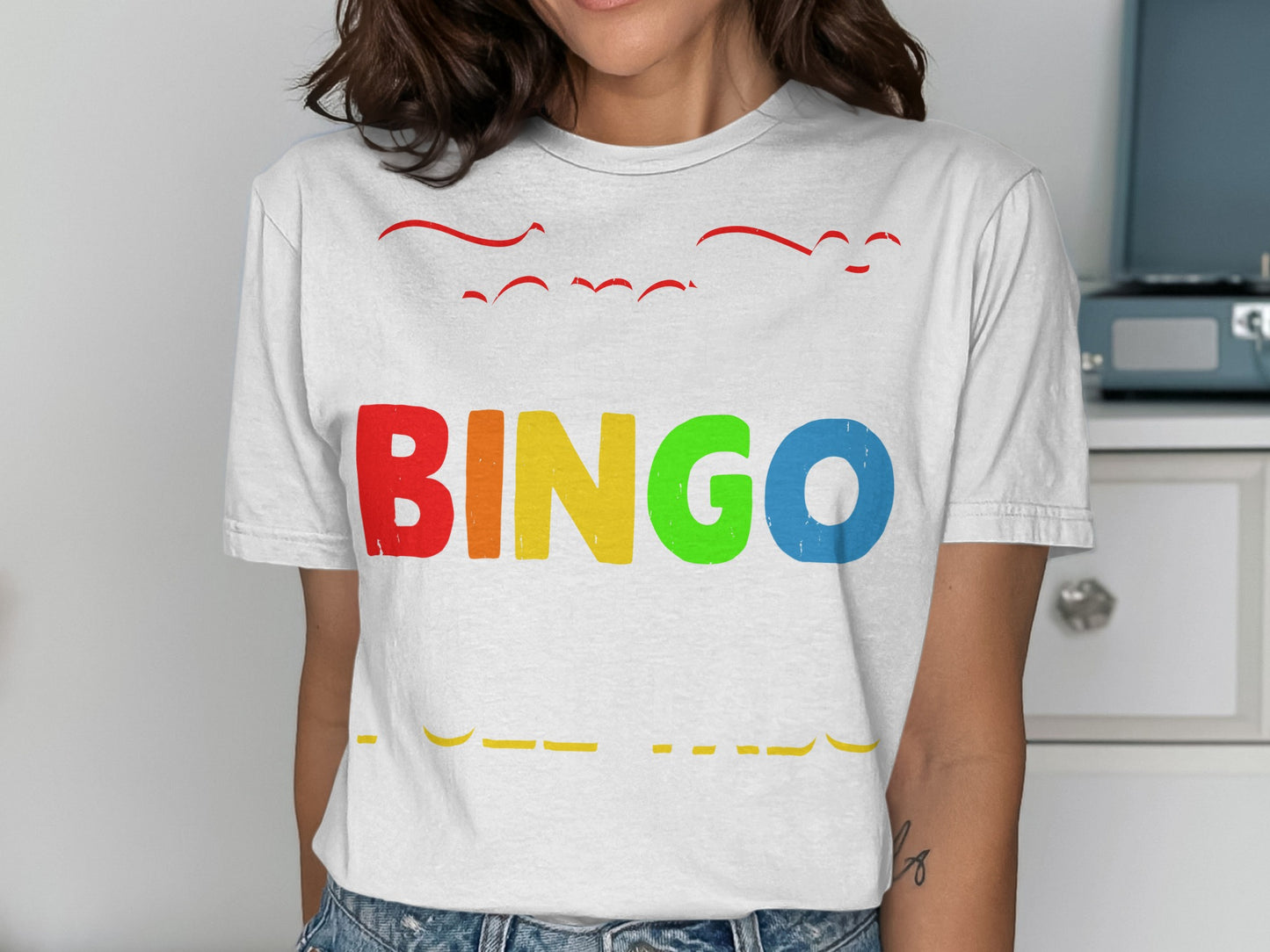 White t-shirt with colorful "BINGO" text and red text above.