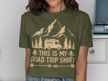Olive green t-shirt with a camper, mountains, trees, and the text "THIS IS MY ROAD TRIP SHIRT".