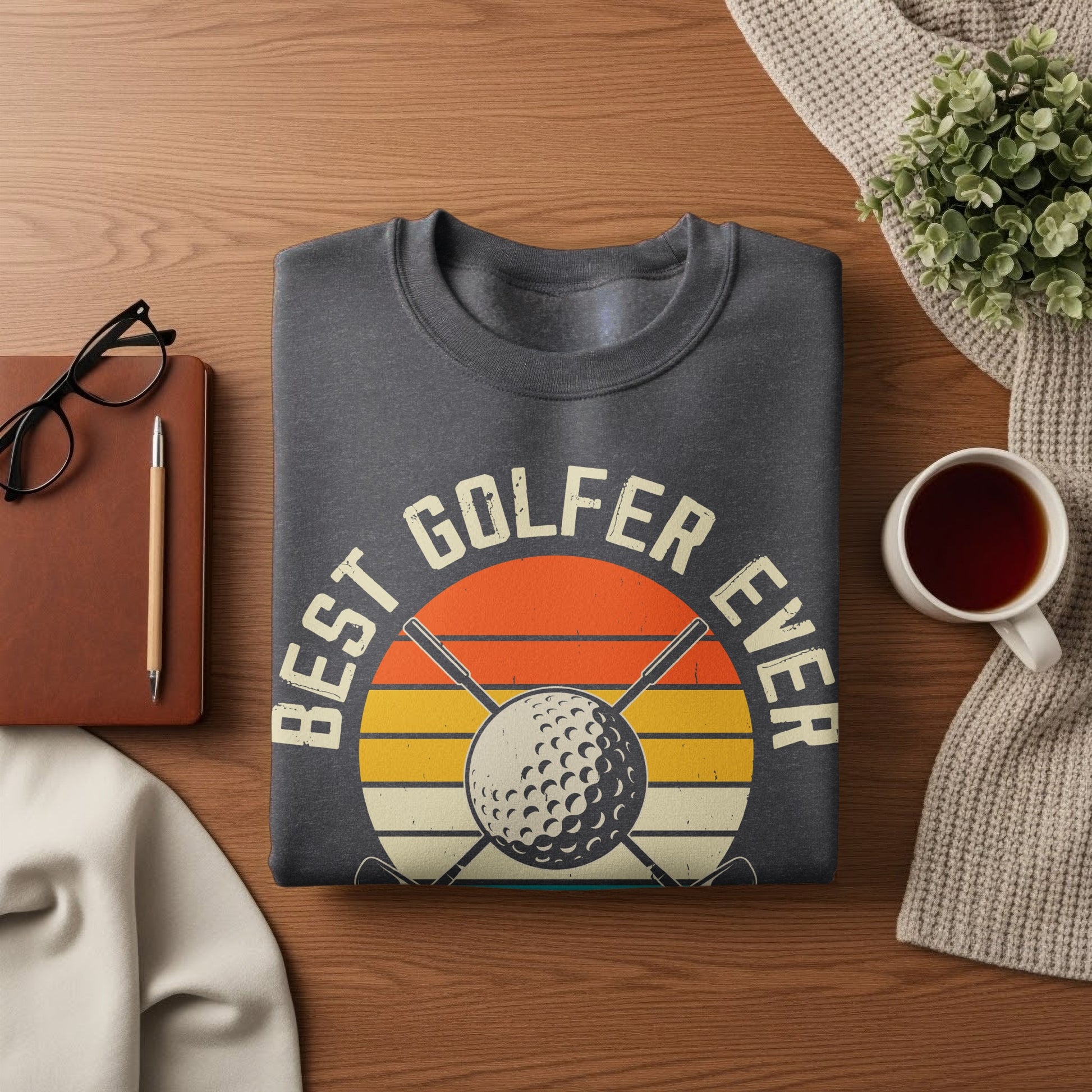 Graphic sweatshirt with "Best Golfer Ever" text and golf ball/clubs design.