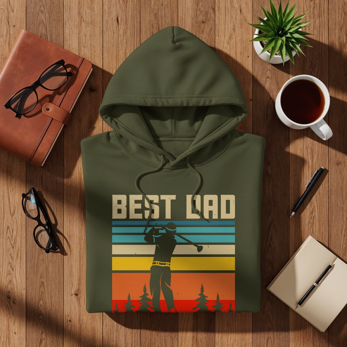 Green hoodie with "BEST DAD" text and a golfer silhouette on striped background.