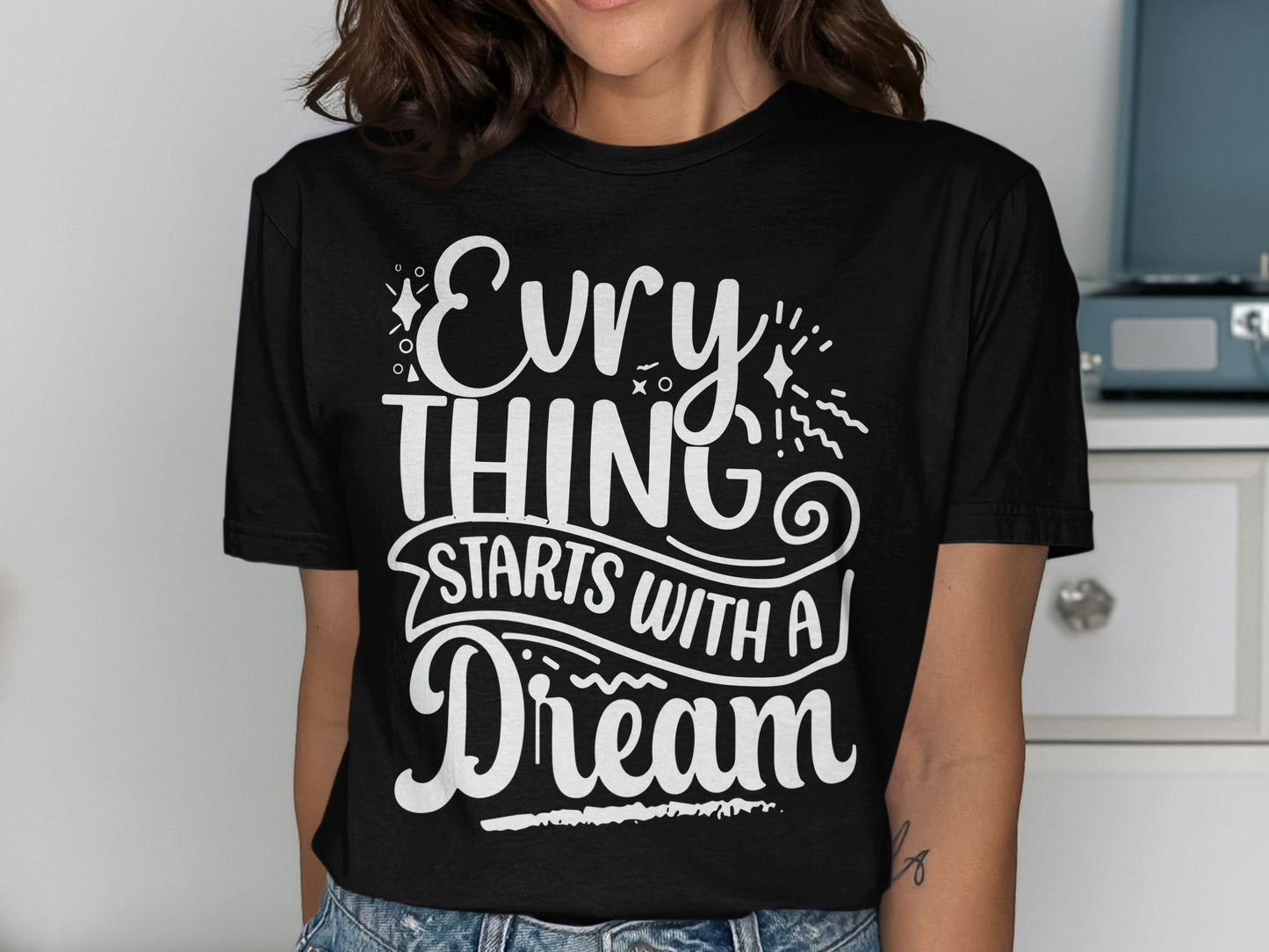 Black t-shirt with white text "EVERYTHING STARTS WITH A DREAM"