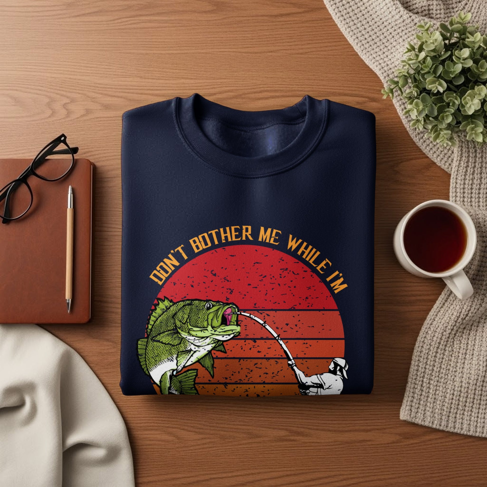 Navy sweatshirt with "Don't bother me while I'm fishing" graphic.