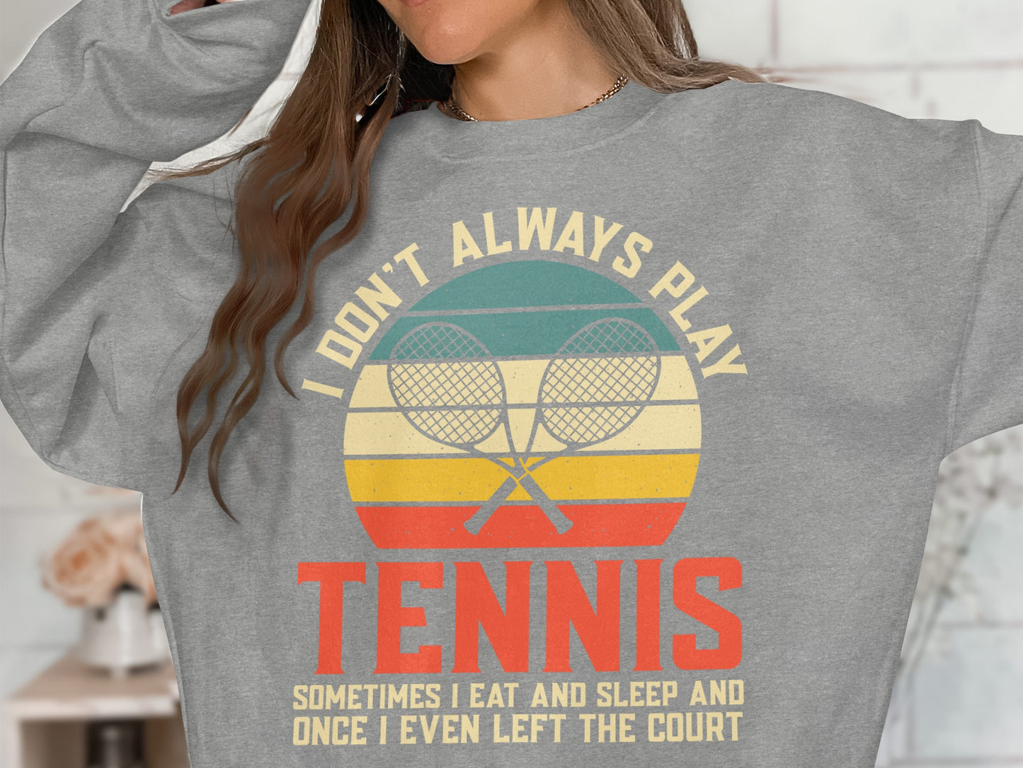 Grey sweatshirt with "I DON'T ALWAYS PLAY TENNIS" graphic.
