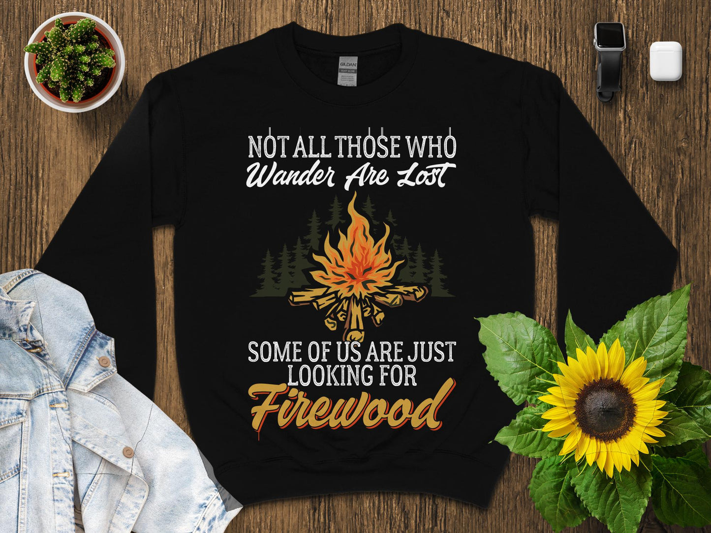 Black sweatshirt with "Not All Those Who Wander Are Lost" and campfire graphic.