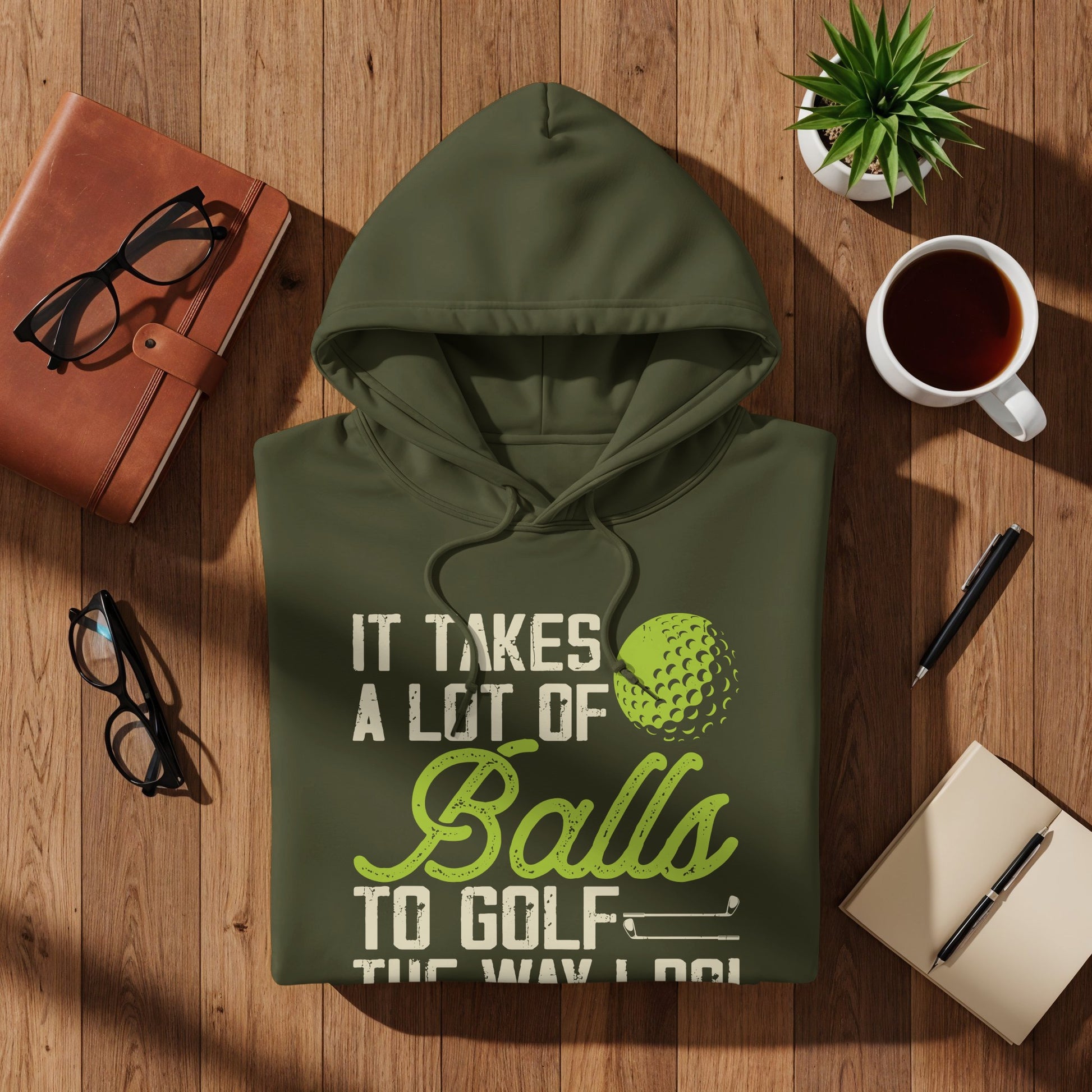 Green hoodie with text "It Takes A Lot of Balls to Golf" and golf ball graphic.
