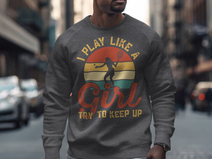 Grey sweatshirt with "Play Like A Girl, Try To Keep Up" text and tennis player graphic.