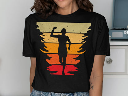 Runner silhouetted against a sunset and pine trees, on a graphic t-shirt.