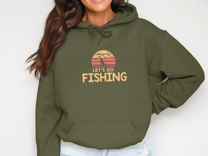 Olive green hoodie with "Let's Go Fishing" graphic and sunset motif.