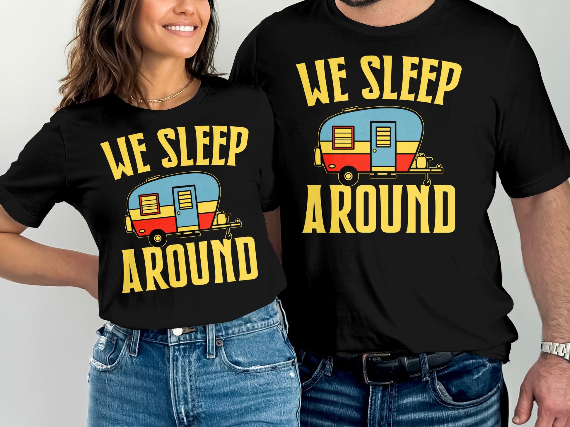 Couple wearing matching "We Sleep Around" t-shirts with RV graphic.
