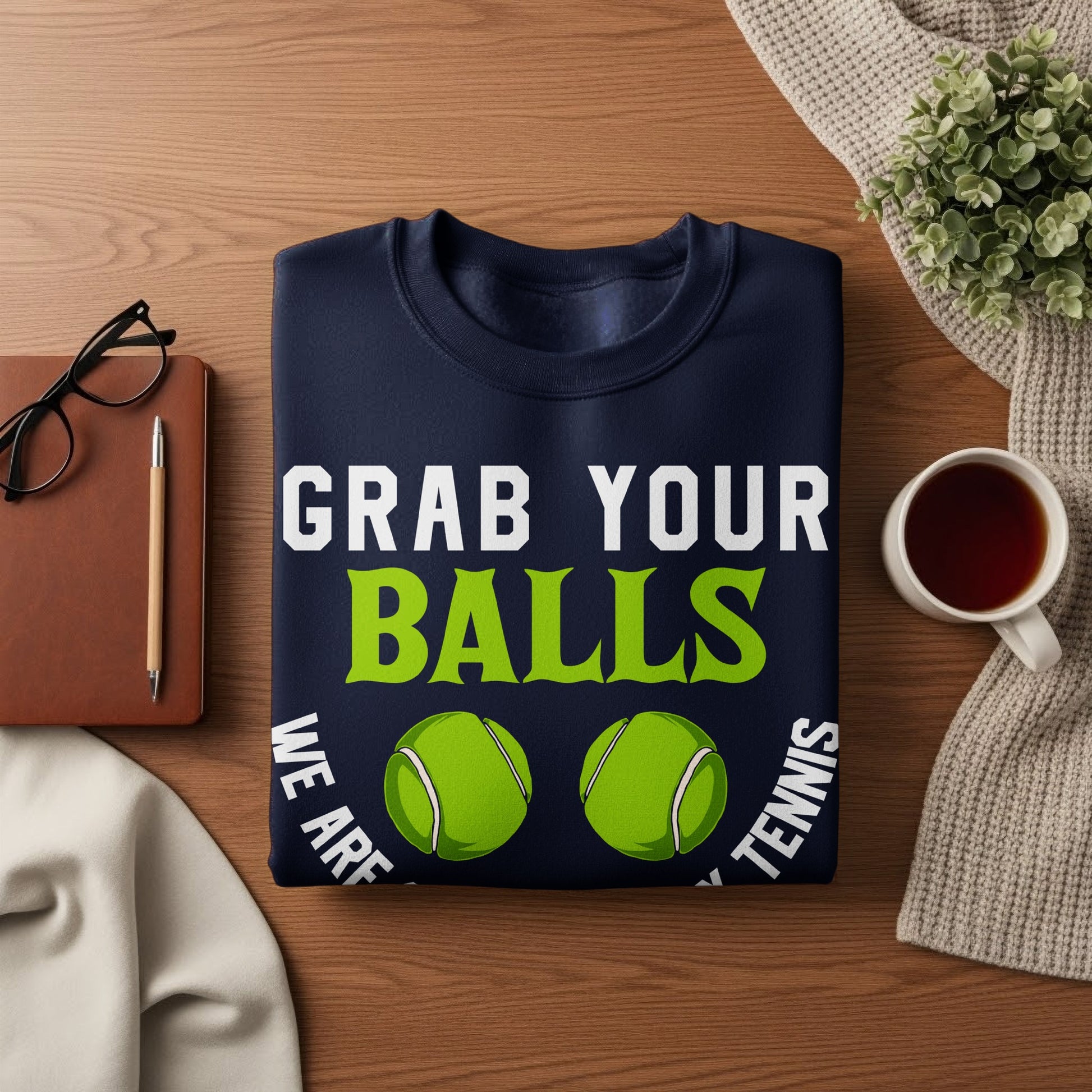 Navy sweatshirt with "GRAB YOUR BALLS" and tennis balls.