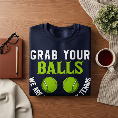 Navy sweatshirt with "GRAB YOUR BALLS" and tennis balls.