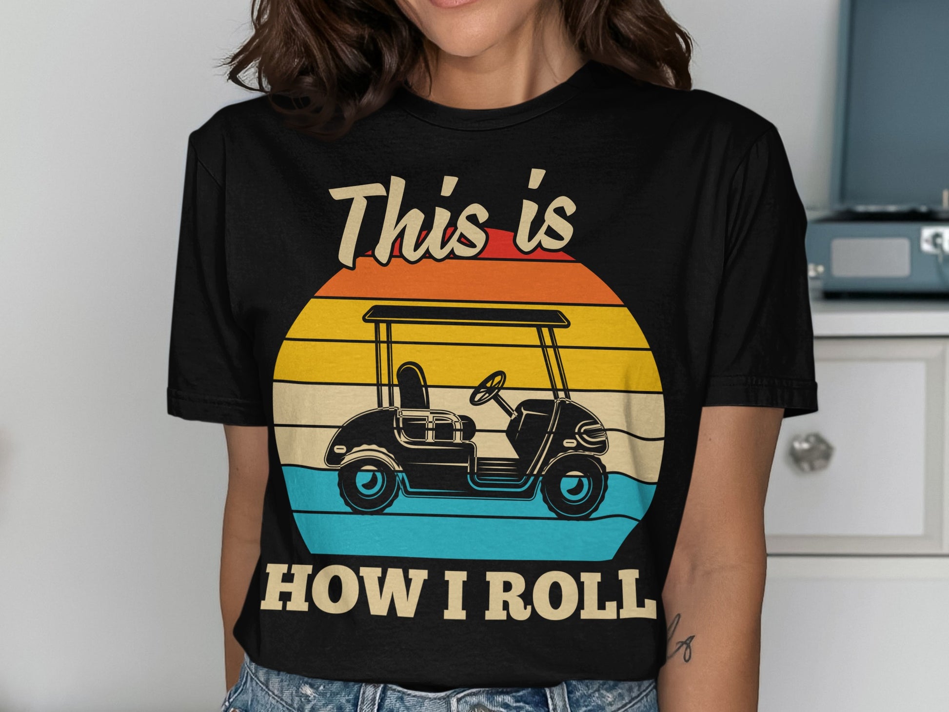 Black t-shirt with "This is how I roll" text and a golf cart graphic.