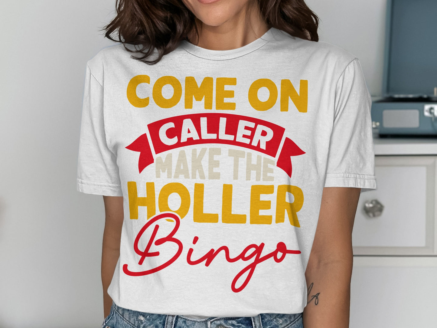 White t-shirt with "COME ON CALLER MAKE THE HOLLER BINGO" text.