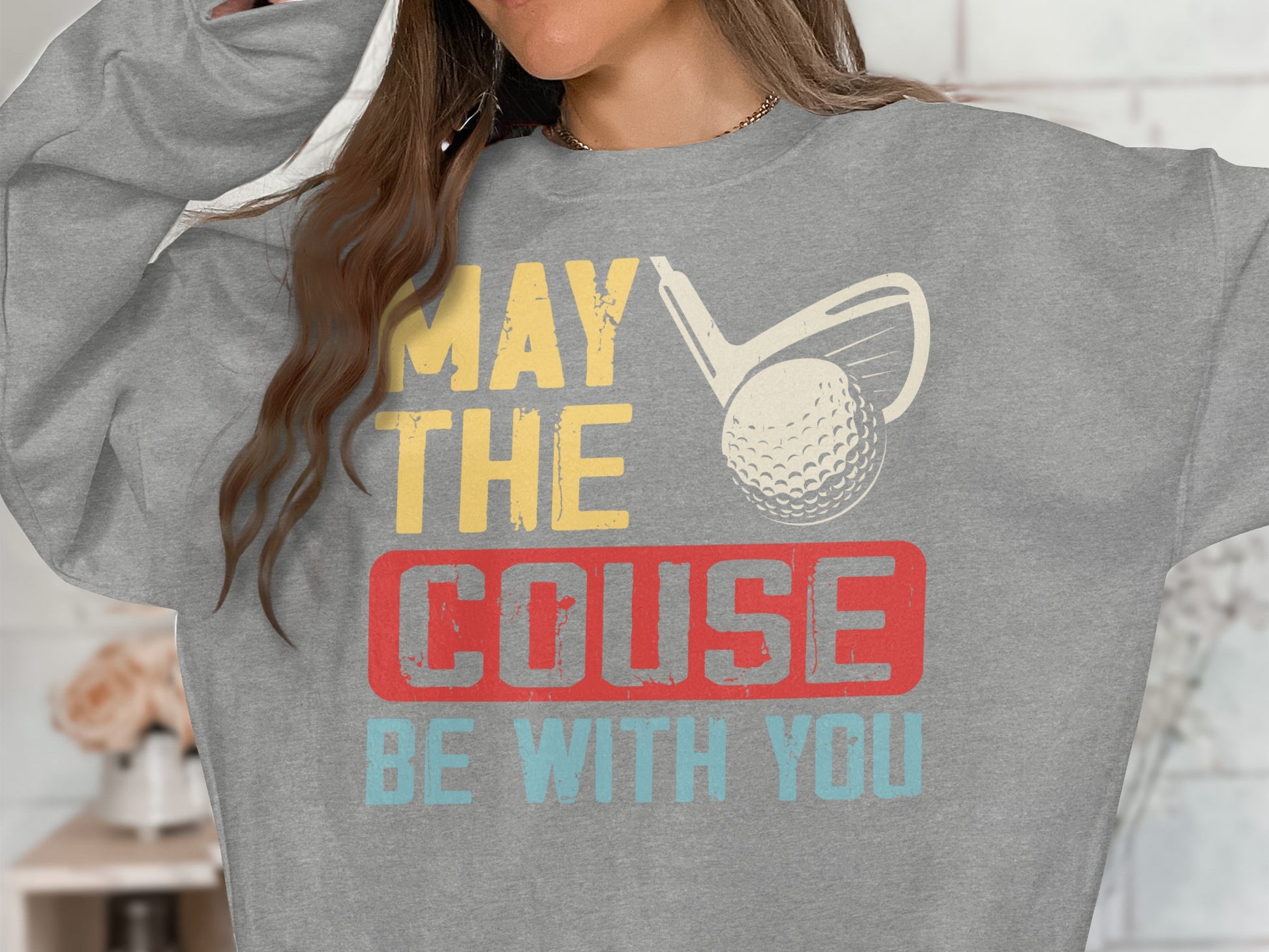 Grey sweatshirt with "MAY THE COUSE BE WITH YOU" and golf club graphic.