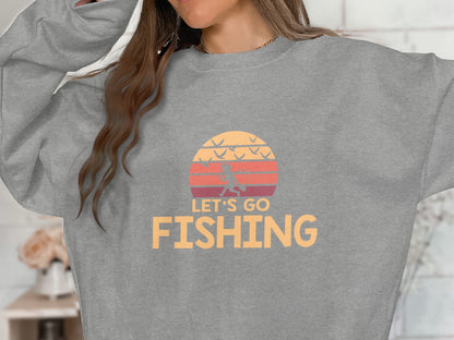 Gray sweatshirt with "Let's Go Fishing" slogan and a sunset graphic.