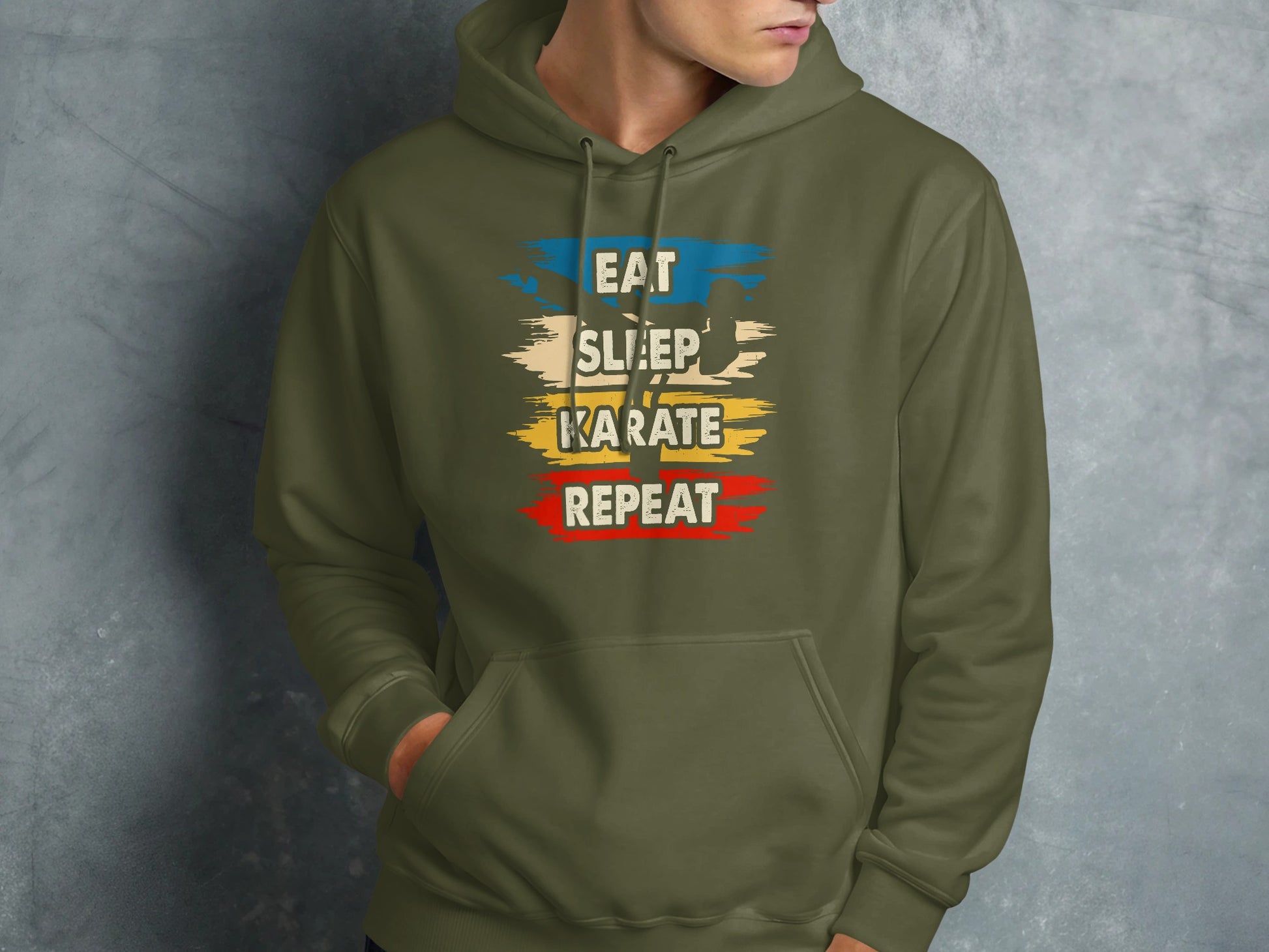 Green hoodie with "Eat Sleep Karate Repeat" text in distressed colorful lettering.