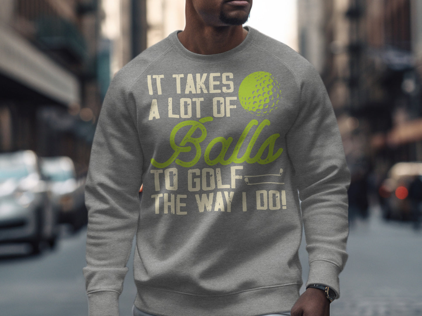 Gray sweatshirt with "It takes a lot of balls to golf the way I do!" text and golf ball graphic.