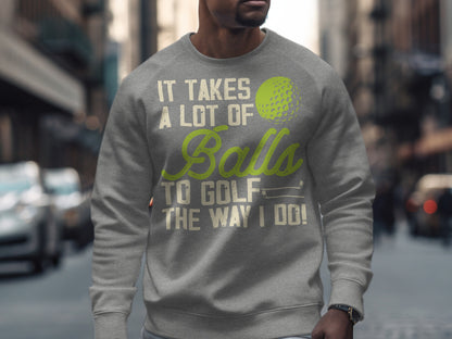 Gray sweatshirt with "It takes a lot of balls to golf the way I do!" text and golf ball graphic.