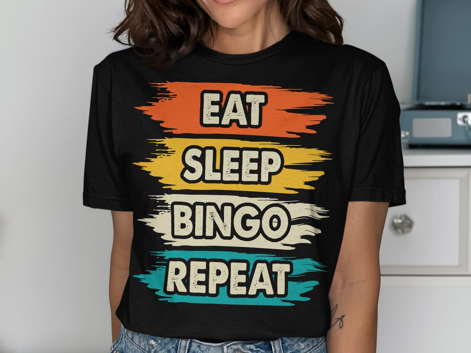 Black t-shirt with "Eat Sleep Bingo Repeat" in colorful text.