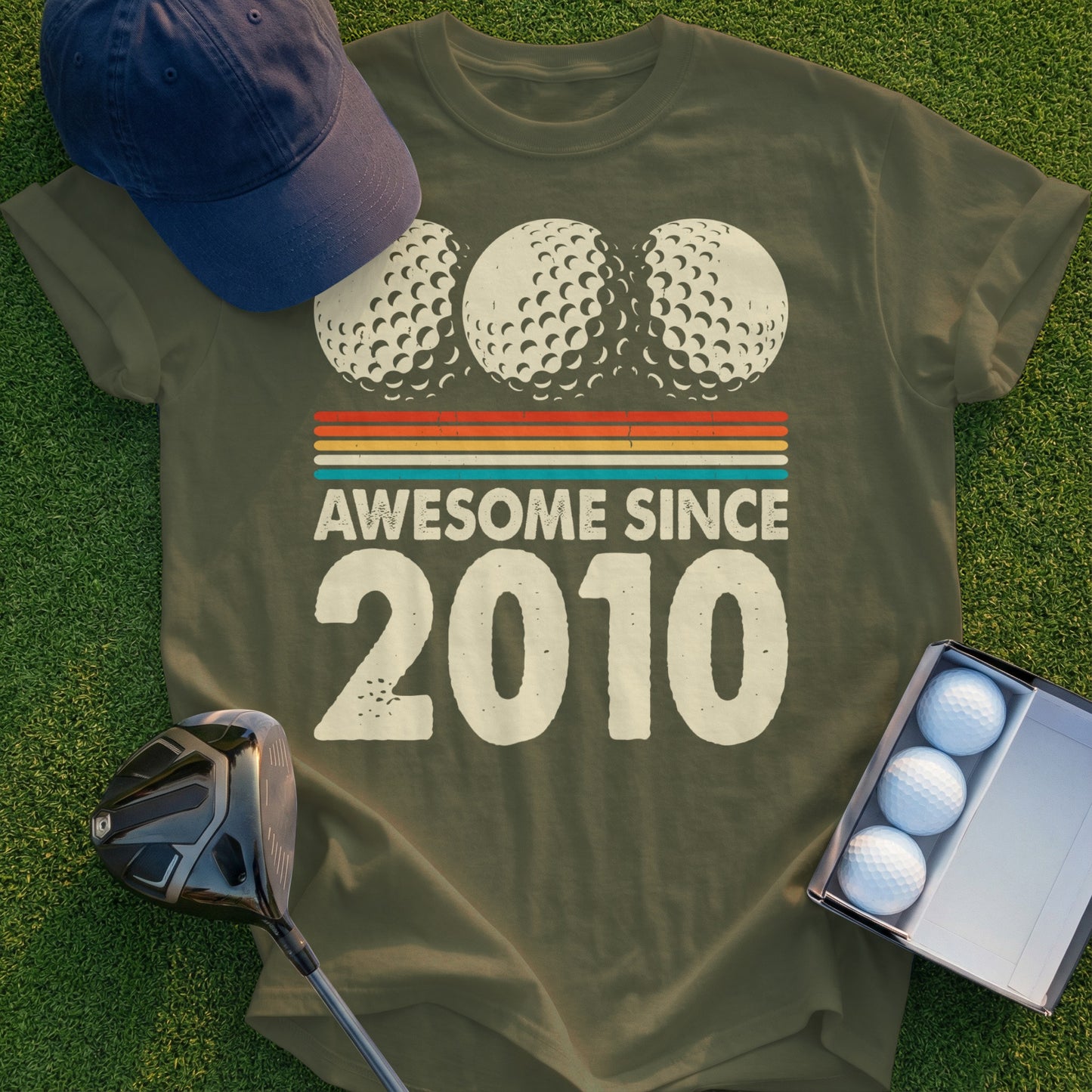 Olive green t-shirt with "Awesome Since 2010" and golf ball graphic.