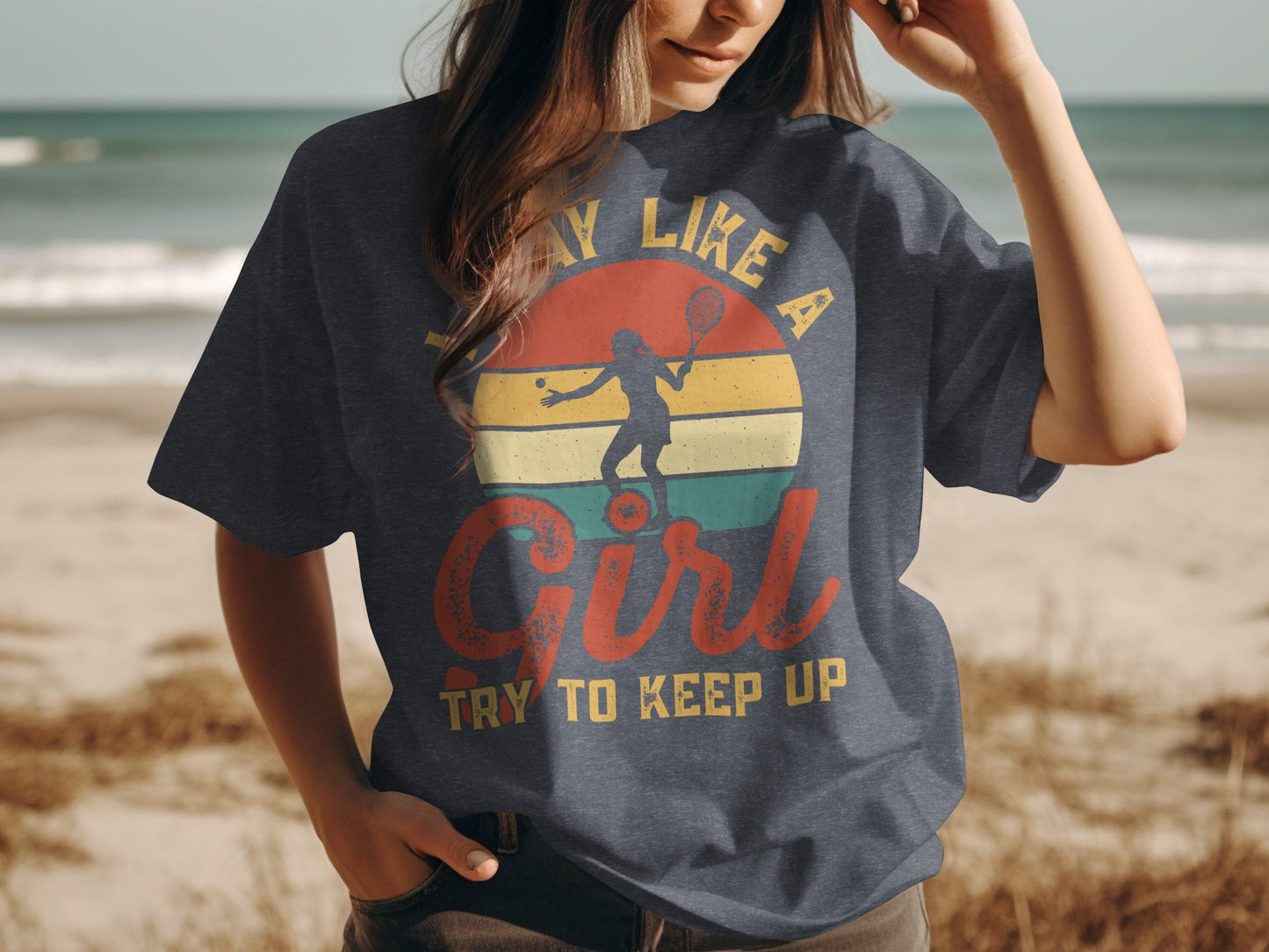 T-shirt with text "Play like a girl, try to keep up" and tennis silhouette.
