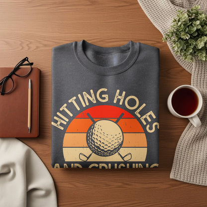 Dark grey sweatshirt with "Hitting Holes" text and golf ball graphic.