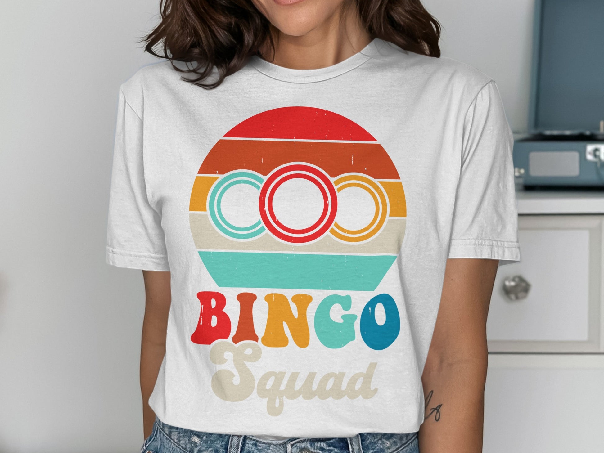 White t-shirt with "BINGO Squad" and colorful retro circles graphic.