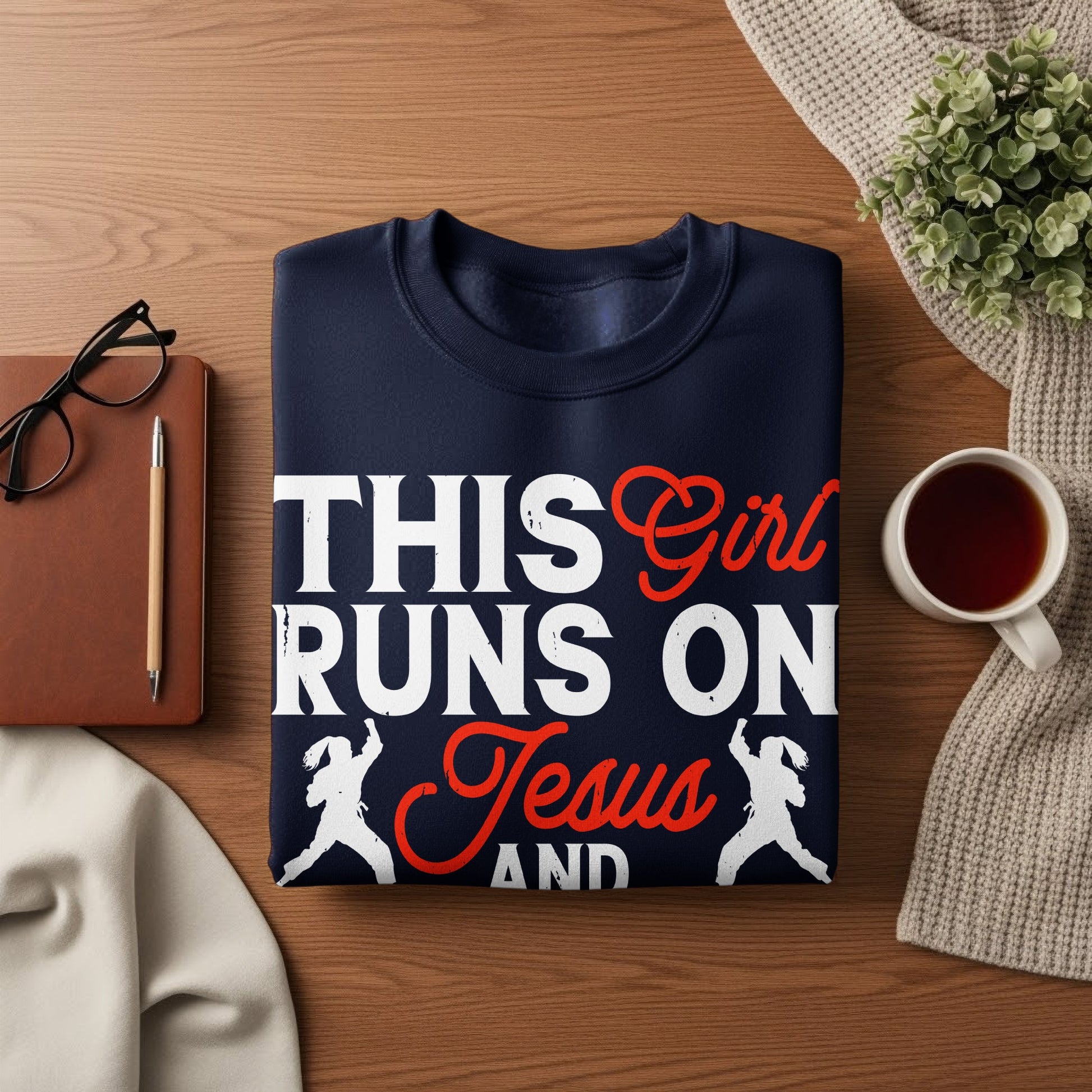 Navy sweatshirt with "This Girl Runs On Jesus And" text and graphic.