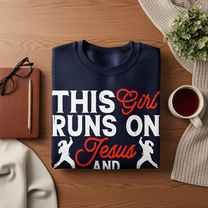Navy sweatshirt with "This Girl Runs On Jesus And" text and graphic.