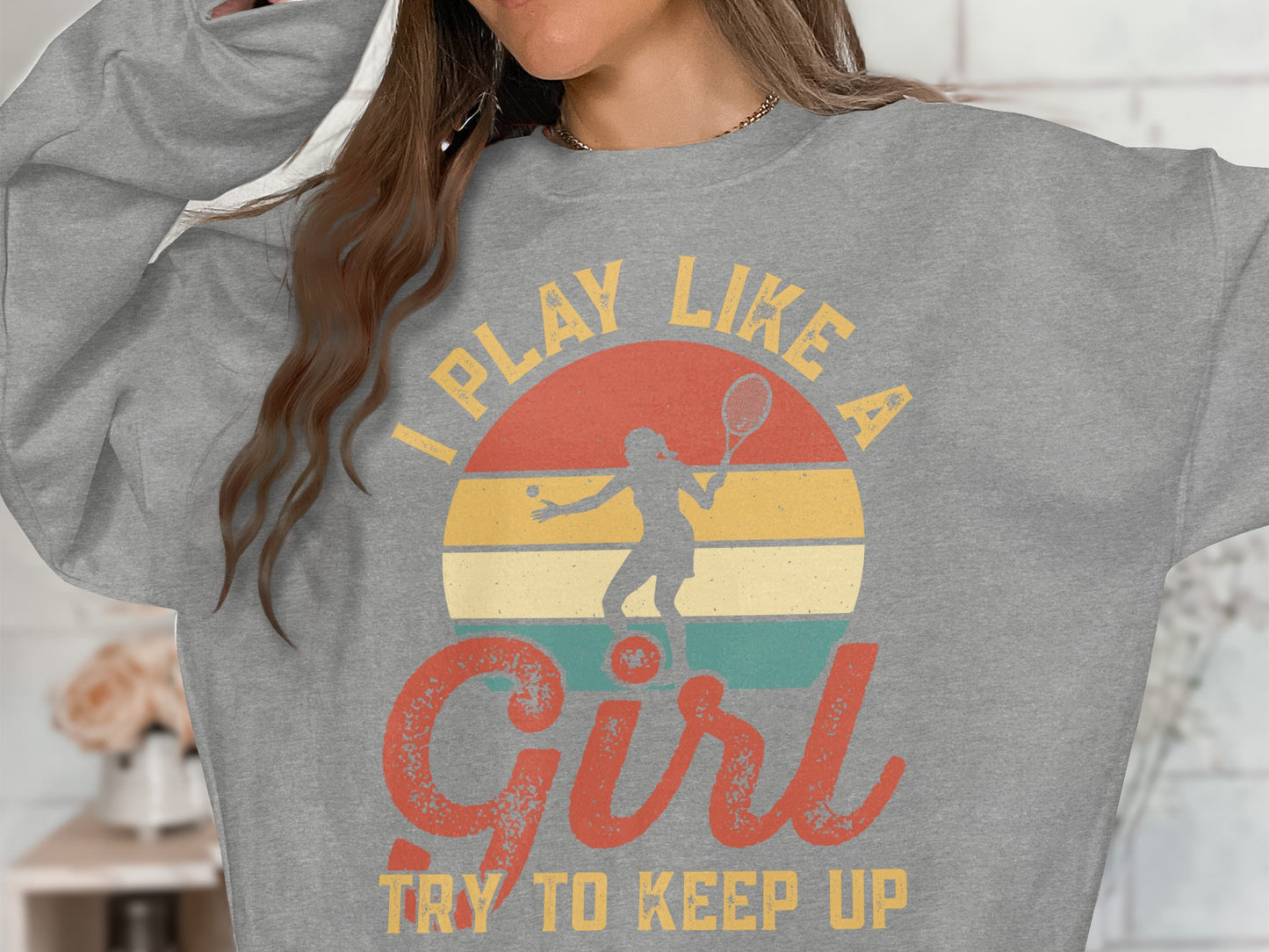 Gray sweatshirt with "I Play Like a Girl Try to Keep Up" text and tennis graphic.