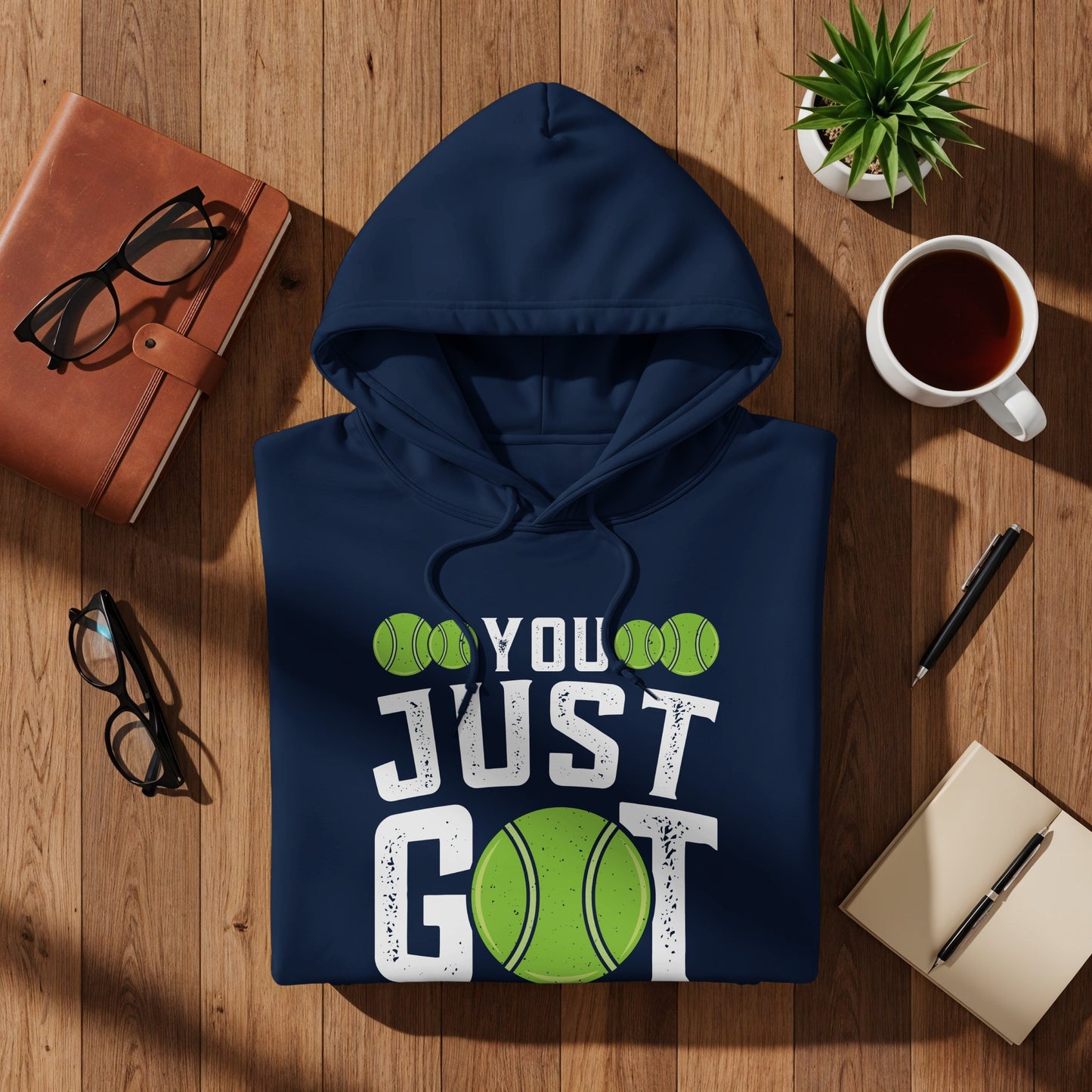 Navy hoodie with "YOU JUST GOT" text and tennis ball graphics.