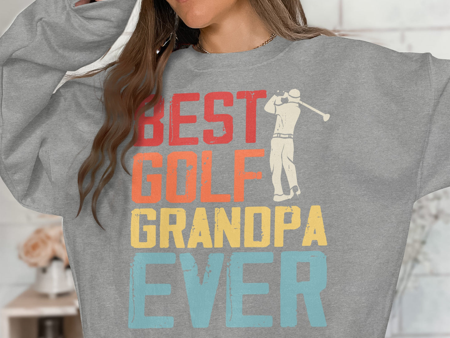 Grey sweatshirt with "BEST GOLF GRANDPA EVER" text and golfer graphic.