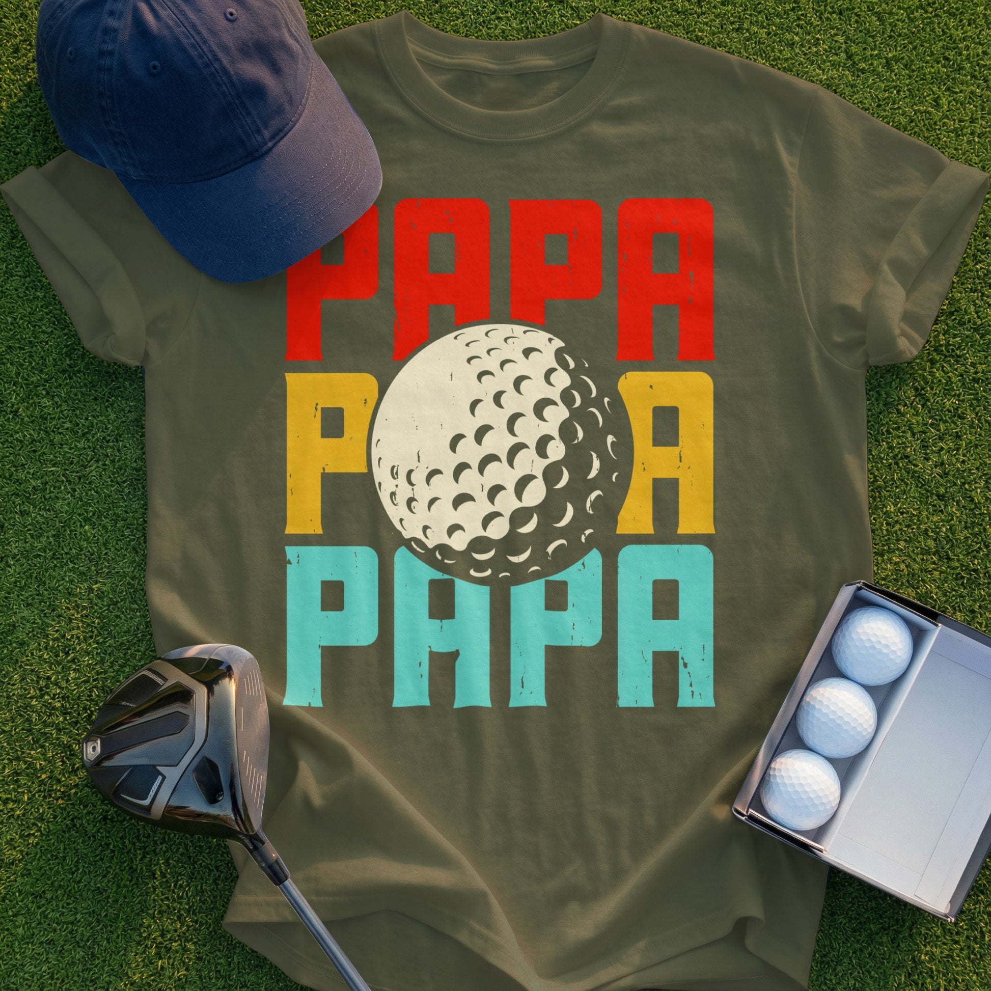 Olive t-shirt with "PAPA" in red, yellow, and blue blocks, featuring a golf ball.