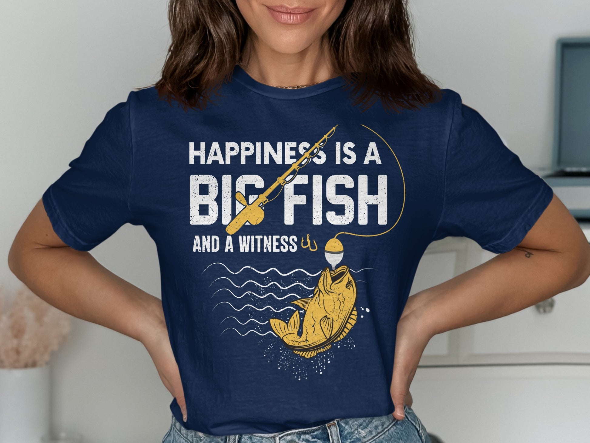 Navy t-shirt with "Happiness is a Big Fish and a Witness" text and fishing graphic.