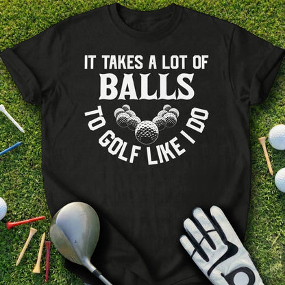 Black t-shirt with "It Takes a Lot of Balls to Golf Like I Do" text and golf balls.