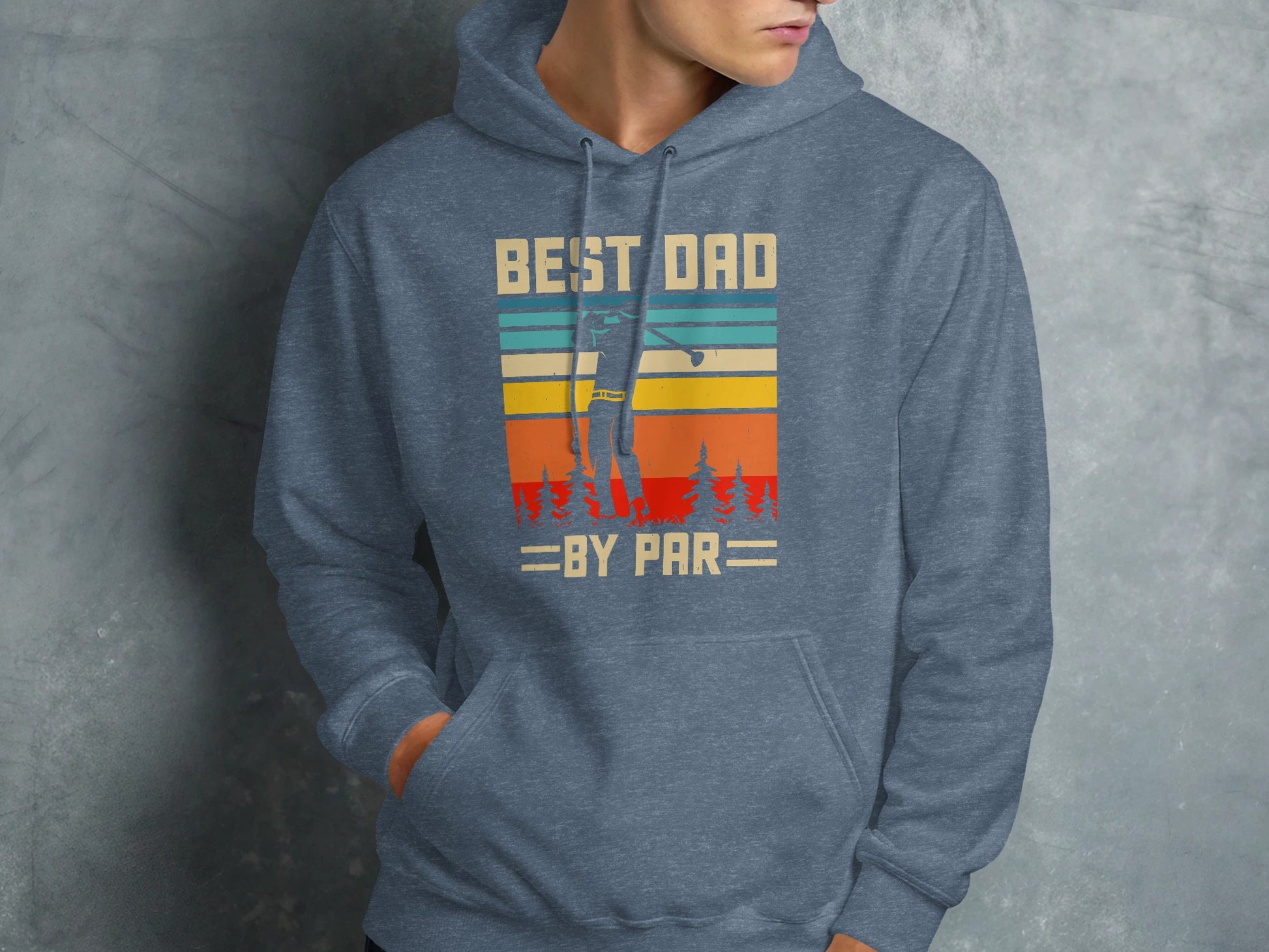 Blue hoodie with "Best Dad By Par" text and vintage sunset golf graphic.
