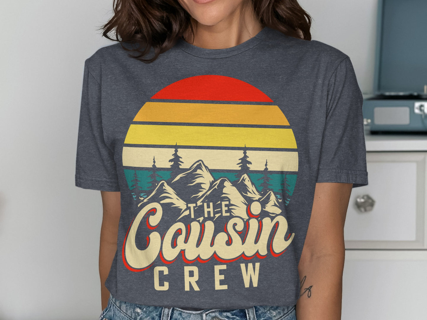 Graphic tee with sunset, mountains, and "The Cousin Crew" text.