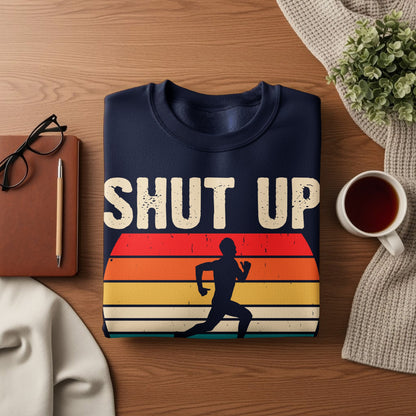 Navy sweatshirt with "SHUT UP" text and runner silhouette on sunset stripes.