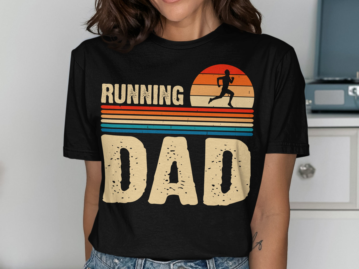Black t-shirt with "RUNNING DAD" in distressed letters and a sunset running graphic.