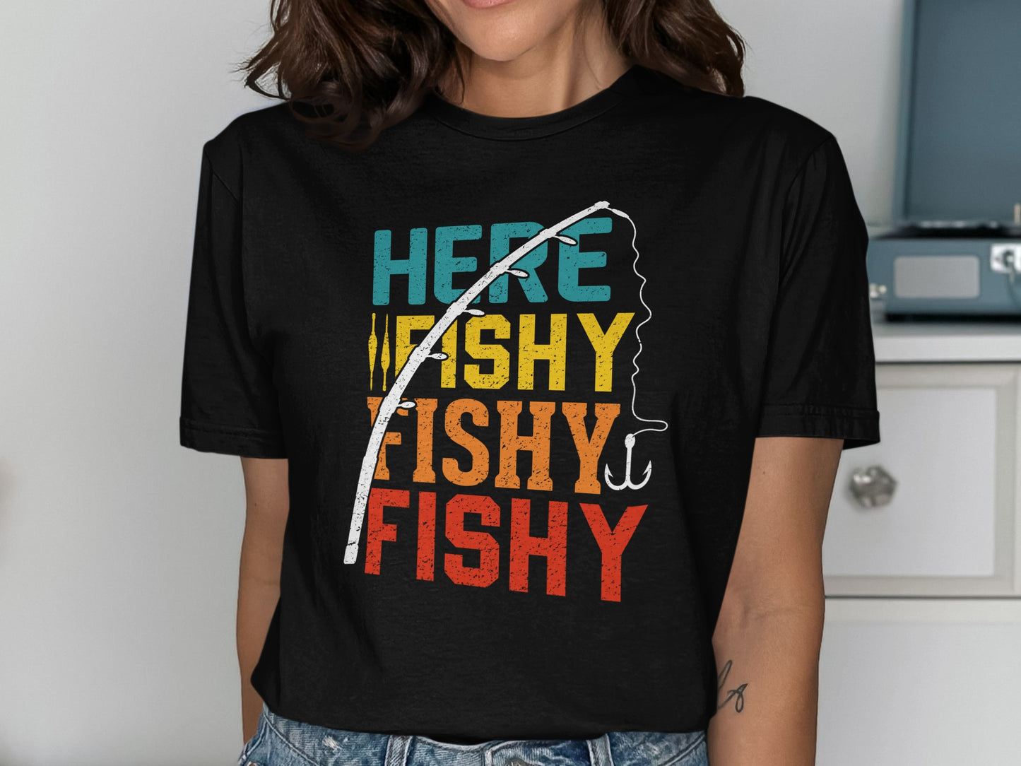 Black t-shirt with "HERE FISHY FISHY FISHY" text and fishing rod graphic.