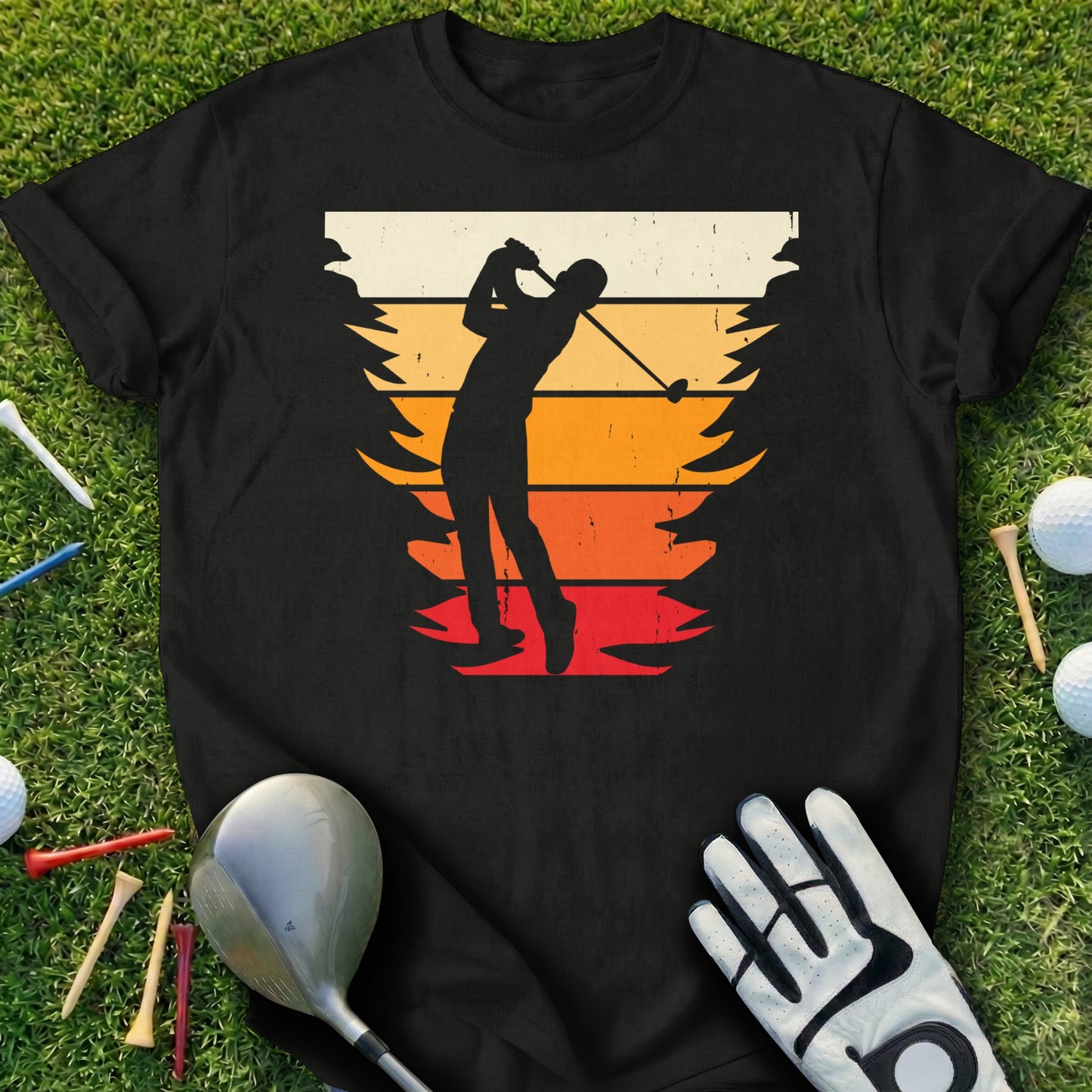 Black t-shirt with silhouette of a golfer swinging, set against a sunset gradient.